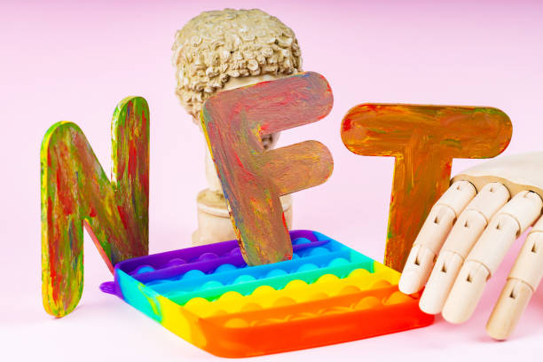 istock NFT Non-Fungible token. Concept for blockchain system. Classical statue and Pop it toy on a pink background. Crypto art concept with an artificial hand 1333162482