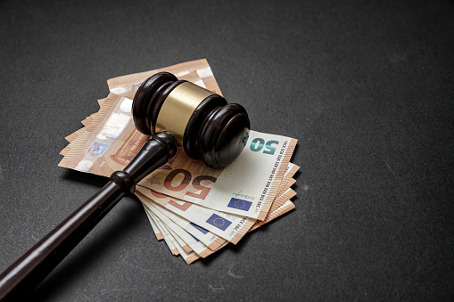 udge or auctioneer gavel on a euro money background