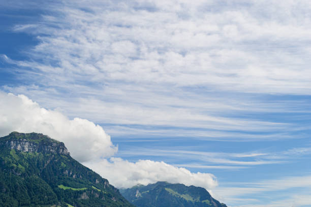 Cirrus cumulus clouds over the mountains. Summer.