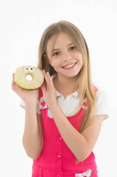 Little girl smile with donut isolated on white. Happy child hold glazed ring doughnut. Kid with junk food. Snack food and dessert.