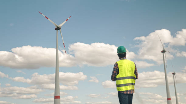 istock Electric engineer inspecting windmill turbine with tablet 1333163902