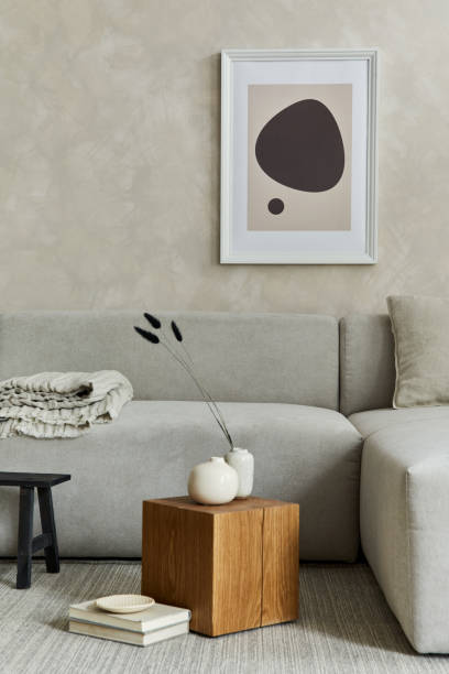 istock Creative composition of stylish japandi living room with mock up poster frame, grey sofa, wooden cubes, design vases and small personal accessories. Creative wall and parquet floor. Details. Template. 1333165045