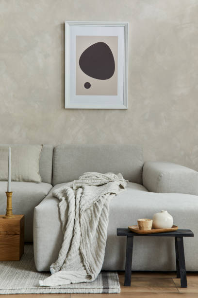 istock Creative composition of stylish japandi living room with mock up poster frame, grey sofa, wooden cubes, design vases and small personal accessories. Creative wall and parquet floor. Details. Template. 1333165107
