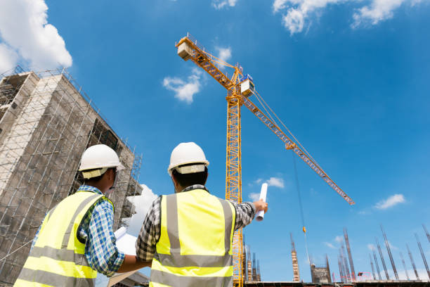Construction engineers discussion with architects at construction site or building site of highrise building stock photo