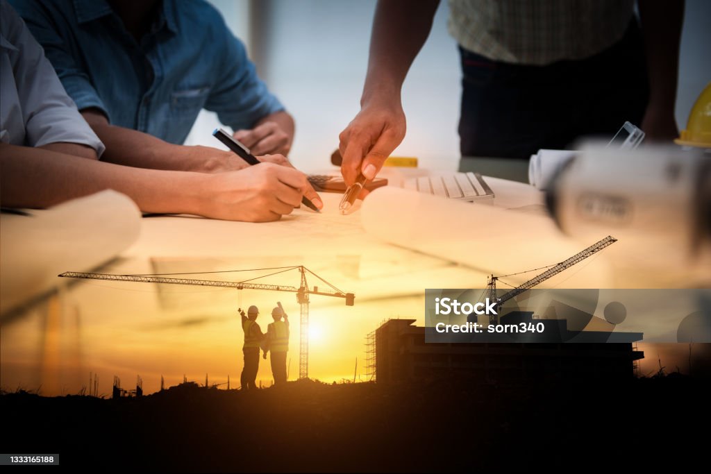 Civil Engineer Jobs, Double exposure of Project Management Team and Construction Site with tower crane background, Day and Night shift on employees job concept. Project Management Stock Photo
