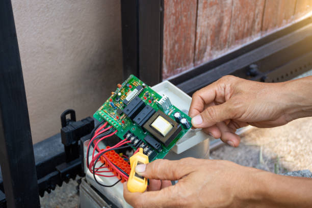 Repairing automatic gate remote controlled. Maintenance concept. Technician man hand using screwdriver tester to measure and test electrical current voltage and checking the functional of motor gear of the automatic door. Maintenance concept. thai door stock pictures, royalty-free photos & images
