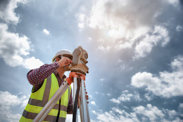 ingeniería topógrafo. topógrafo usando telescopio en el sitio de construcción, topografía para hacer planes de contorno son una representación gráfica de la disposición de la tierra antes de los trabajos de construcción de inicio. - inspector safety construction reflective clothing fotografías e imágenes de stock