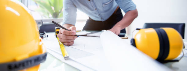 Engineer Designer People Drawing and Planning with Blueprint Architecture on Desk office. Drafting and Design Worksheets Before Startup Project Concept.
