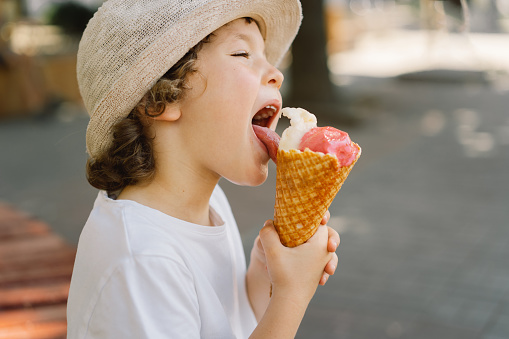 Close-up view of boy eating ice cream in garden. Sweden.
