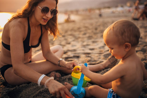 istock Mother and son playing on the beach 1333170775