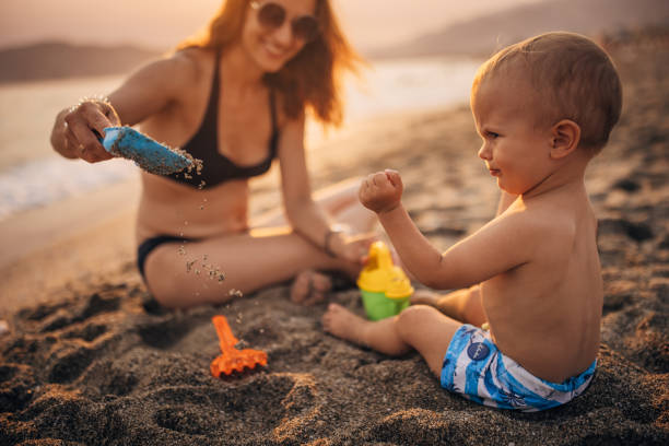 istock Mother and son playing on the beach 1333170820