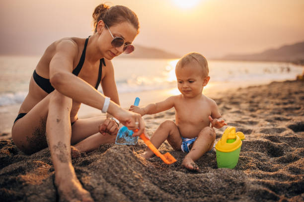 istock Mother and son playing in sand 1333171435