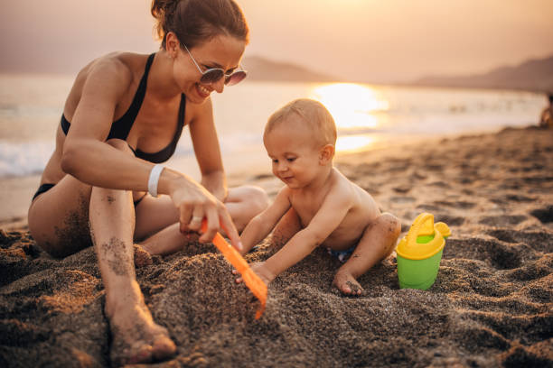 istock Mother and son playing in sand 1333171465