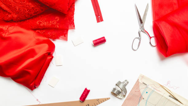 istock Women hobby. Sewing accessories. Set for tailor shop with thread, scissors, red fabric on white background top view copy space 1333171811