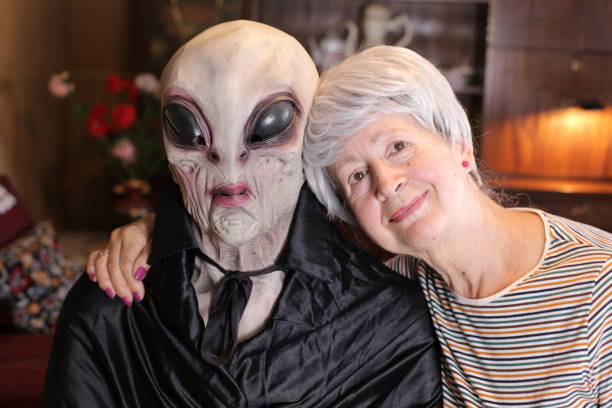 Ecstatic senior woman taking a pic with an alien Ecstatic senior woman taking a pic with an alien. ugly old women stock pictures, royalty-free photos & images