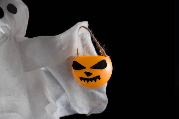 istock Decorative background for Halloween, white ghosts with pumpkins 1333173437