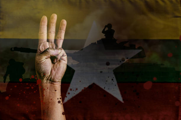 conceito de protestos de mianmar, três dedos para cima de ativista com bandeira de mianmar e fundo de soldado com espaço de cópia. - myanmar - fotografias e filmes do acervo