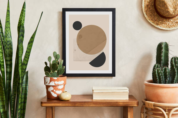 istock Creative composition of stylish living room interior with mock up poster frame, cacti and personal boho accessories. Plant love and nature concept. Template. 1333175681