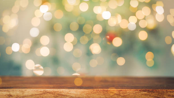 istock Wooden table on blurry christmas lights background 1333177741