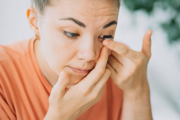 istock Young girl with poor eyesight puts on lens for vision 1333177822