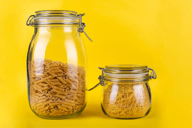 istock pasta in a glass jar on a yellow background isolated 1333178005