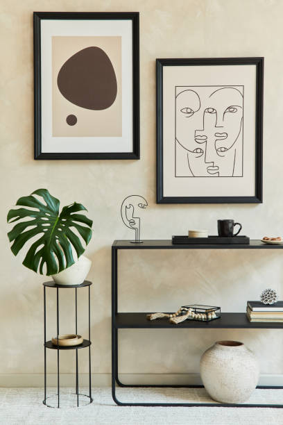 istock Creative composition of stylish modern living room interior with two mock up poster frames, black geometric commode, armchair, lamp and personal accessories. Neutral colours. Template. 1333179874