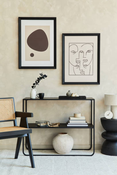 istock Creative composition of stylish modern living room interior with two mock up poster frames, black geometric commode, armchair, lamp and personal accessories. Neutral colours. Template. 1333179892