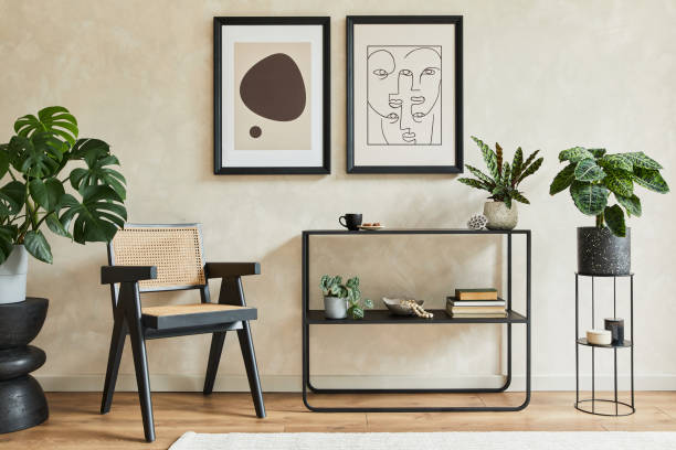 istock Creative composition of stylish modern living room interior with two mock up poster frames, black geometric commode, armchair, lamp and personal accessories. Neutral colours. Template. 1333179897