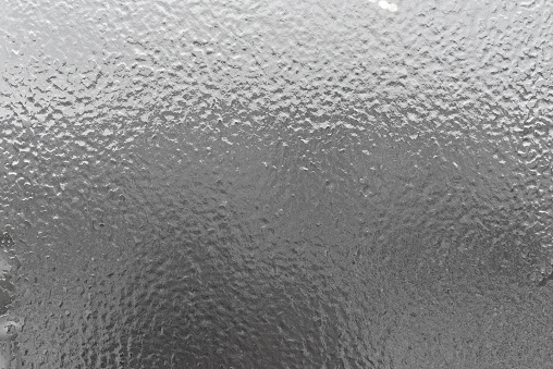 Closeup of icy frost background on glass