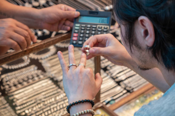 Guy tries on silver rings in india market