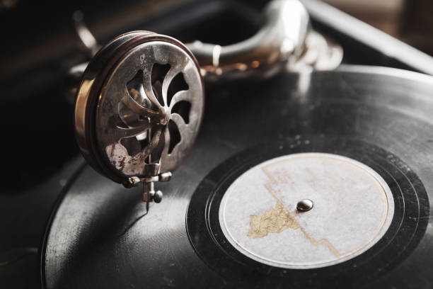 Vintage phonograph with black vinyl record Vintage phonograph with black vinyl record plays an old music, close up photo with selective soft focus gramophone stock pictures, royalty-free photos & images