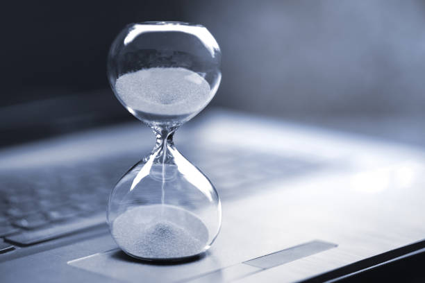 Hourglass on laptop computer Hourglass on laptop computer countdown photos stock pictures, royalty-free photos & images