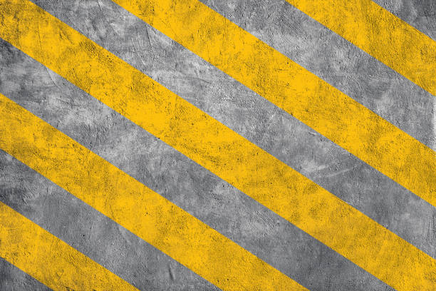 istock Yellow caution warning lines on concrete floor grunge texture background. 1333187293