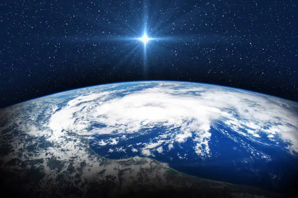 Christmas star over the Earth. Christmas of Jesus Christ. Elements of this image furnished by NASA - https://www.nasa.gov/sites/default/files/thumbnails/image/iss044e001198.jpg