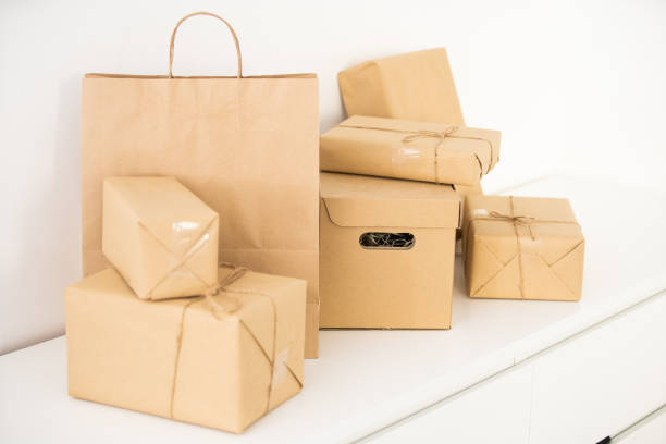 istock Craft paper bags and cardboards blank box presented on table, isolated on white background. 1333187364