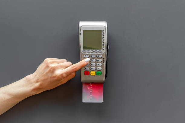 istock Hand swiping credit card by pos terminal. Payment transactions concept 1333188549