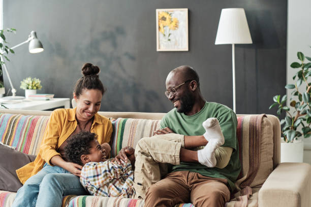 istock Parents playing with child at home 1333190271