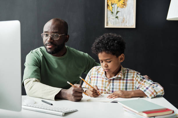 istock Father studying with his son at home 1333190283