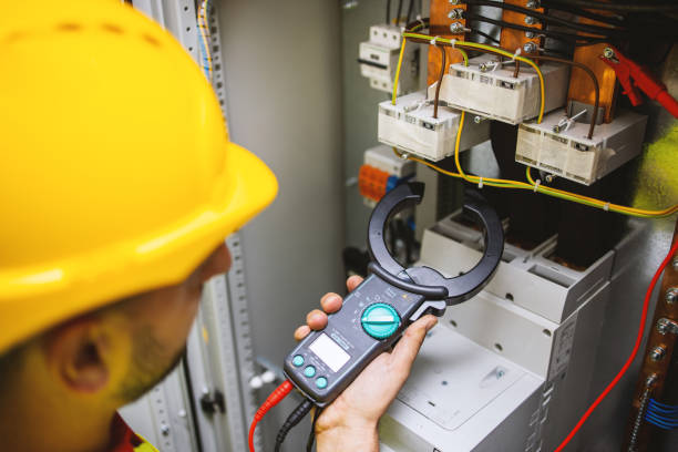 istock Electrician engineer work tester measuring voltage and current of power electric line in electical cabinet control. 1333190458