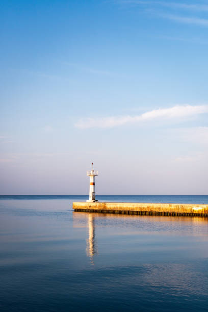 istock view of white lighthouse with breakwater. Mediterranean. 1333192131
