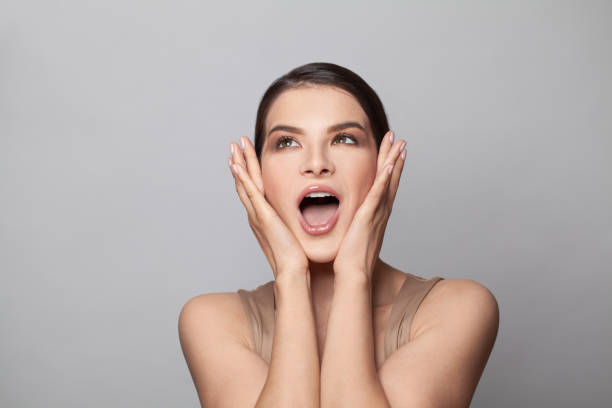 istock Shocked surprised woman with open mouth on white background 1333192806