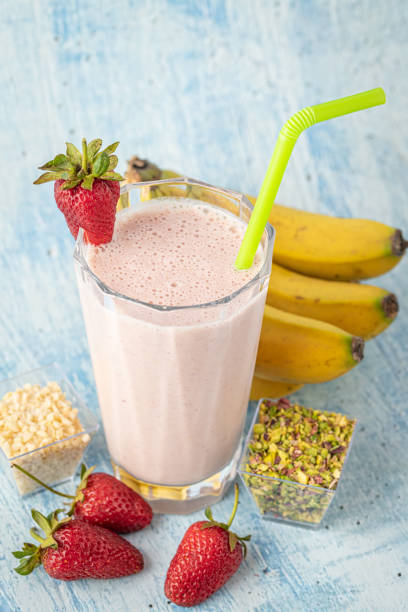 istock Strawberry and banana cold smoothie on blue background 1333194022
