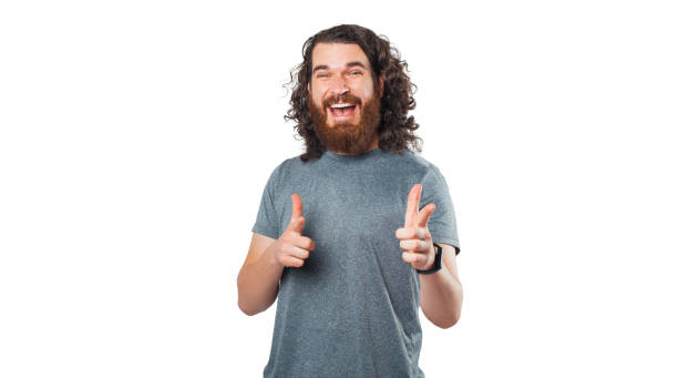 istock Hey you look at this, happy young bearded man pointing at camera over white background 1333196048