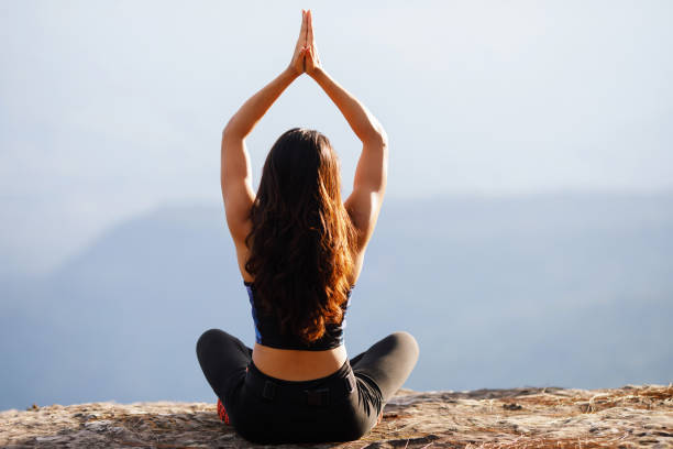 istock Young woman is practicing yoga at mountain in the summer 1333196122
