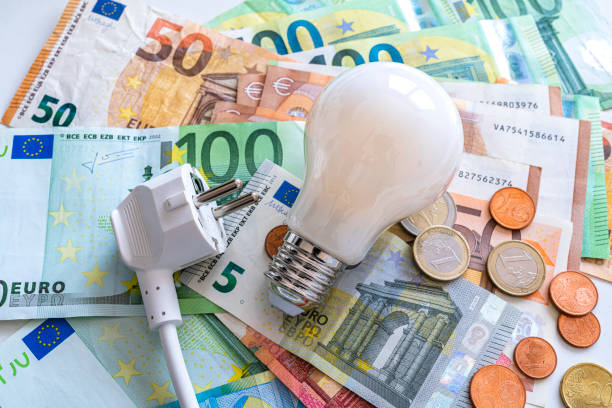 istock Electric plug and light bulb on Euro banknotes 1333197474
