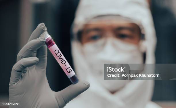 Covid19 Named By Who For Novel Coronavirus Ncp Concept Doctor Or Lab Technician In Ppe Suit Holding Blood Sample With Novel Coronavirus In Wuhan Hubei Province China Medical And Healthcare Stock Photo - Download Image Now