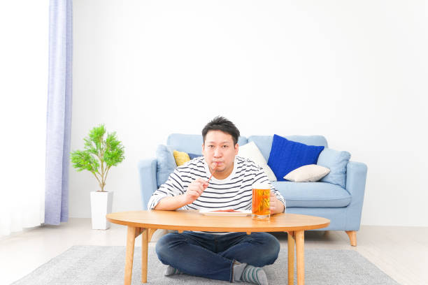 istock Middle-aged man drinking beer at home 1333202304
