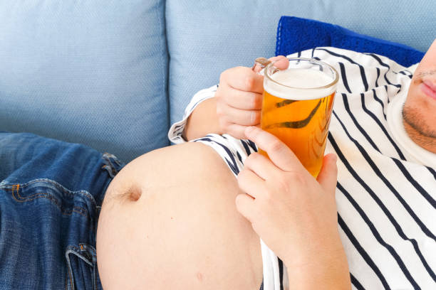 istock Middle-aged man drinking beer at home 1333202306