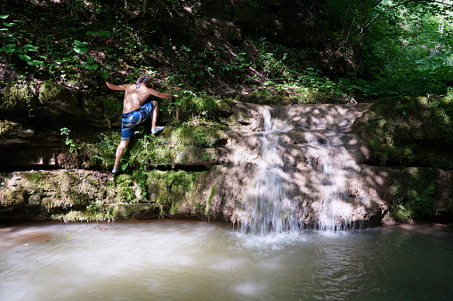 Young adventurer trekking on the challenging waterfall path, Erfelek Waterfall, Sinop