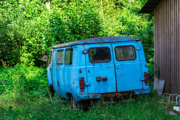 istock An old broken down abandoned car of blue color standing among the greenery 1333205016